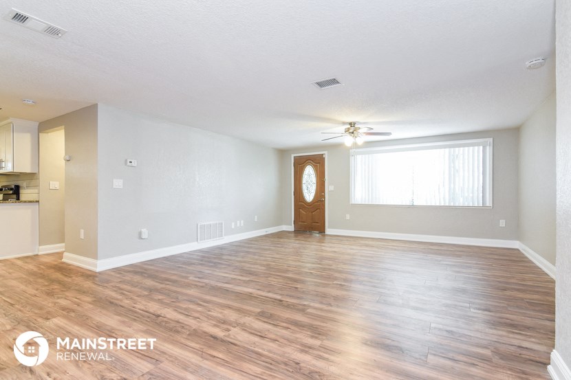 the living room and dining room with wood flooring