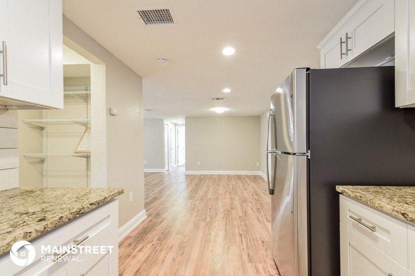 a kitchen with a refrigerator and a walk in closet