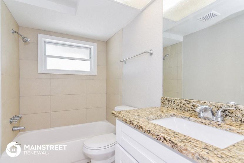 a bathroom with a sink and a toilet and a tub