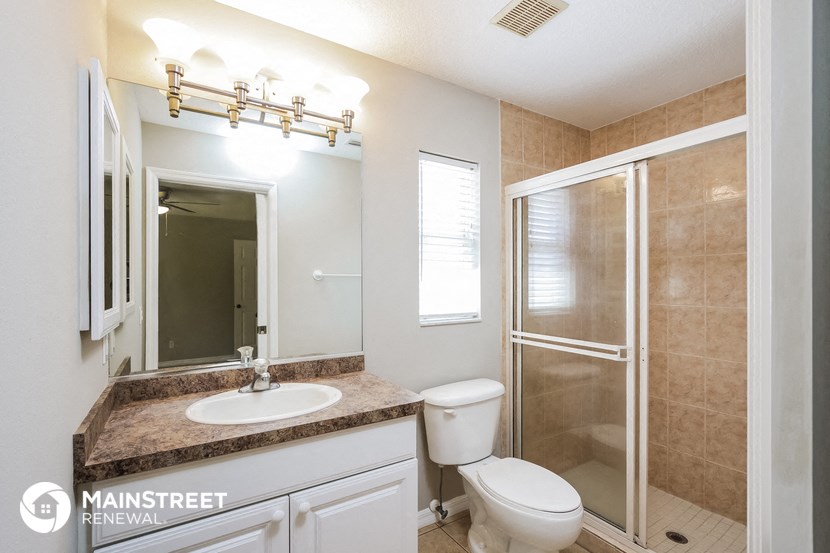 a bathroom with a sink toilet and a shower