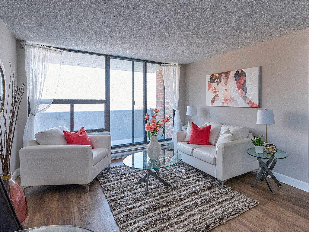 a living room with two couches and a glass table