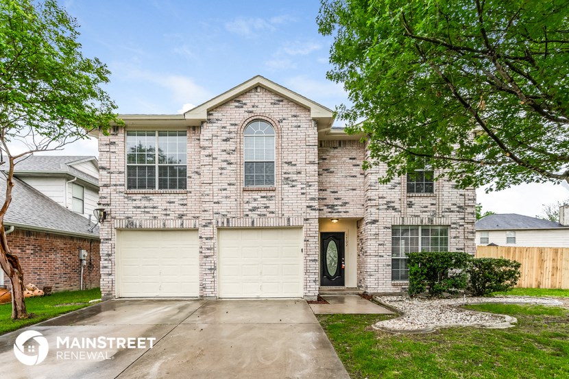 a white brick house with a white garage door
