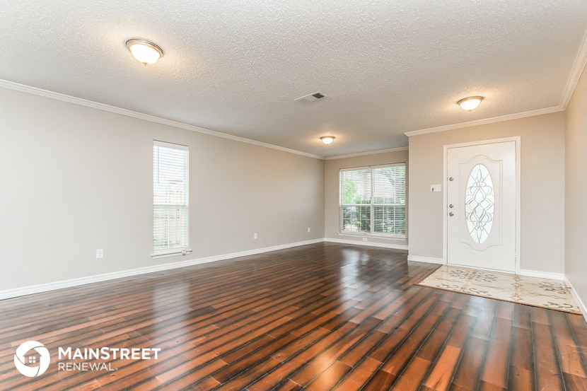 the living room and dining room with hardwood flooring