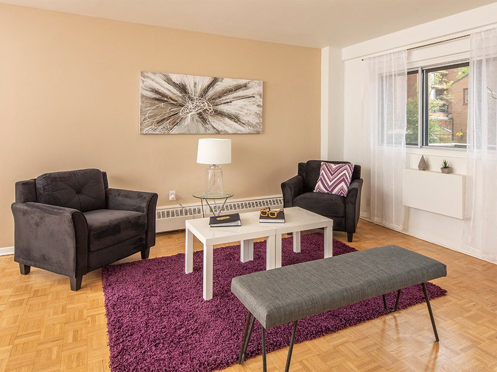 a living room with two chairs and a table