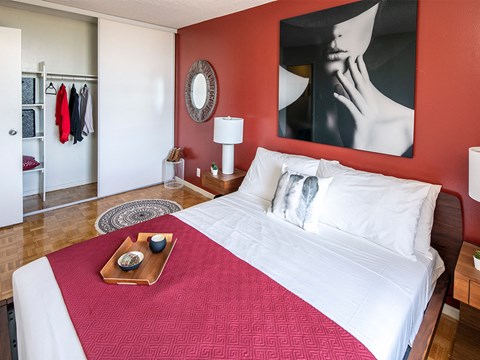 a bedroom with red walls and a white bed with a red blanket