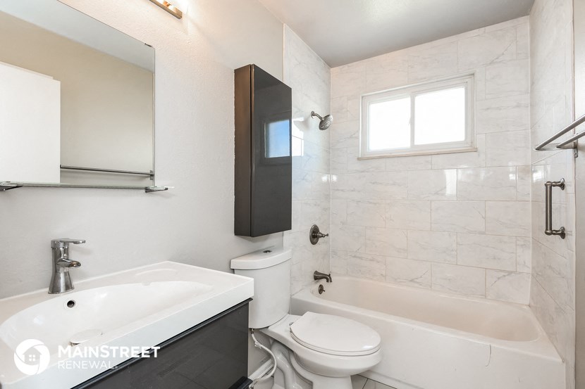 a bathroom with a sink toilet and a bath tub
