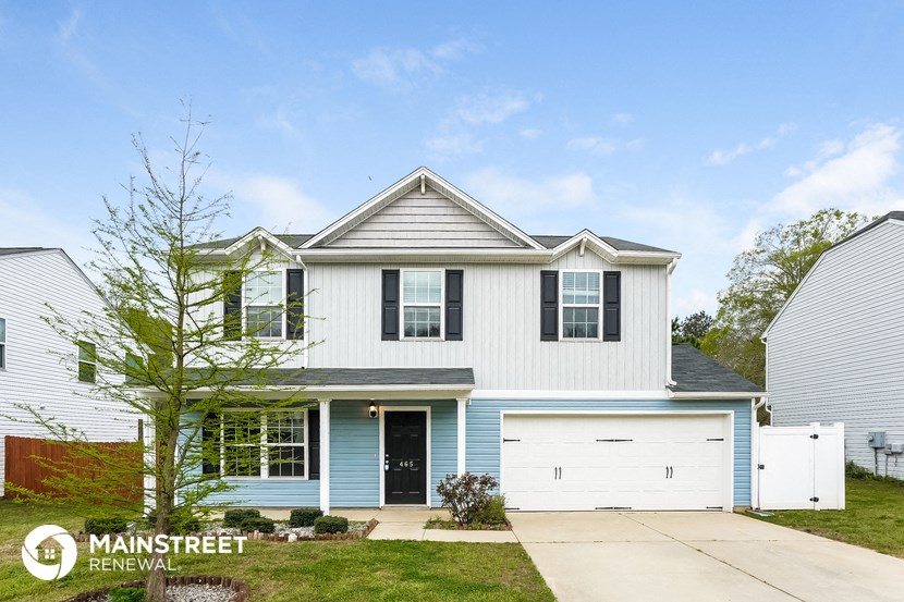 a blue and white house with a white garage door