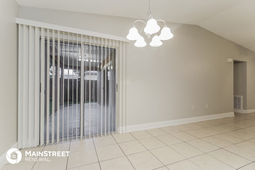 the living room with the sliding glass door to the garage