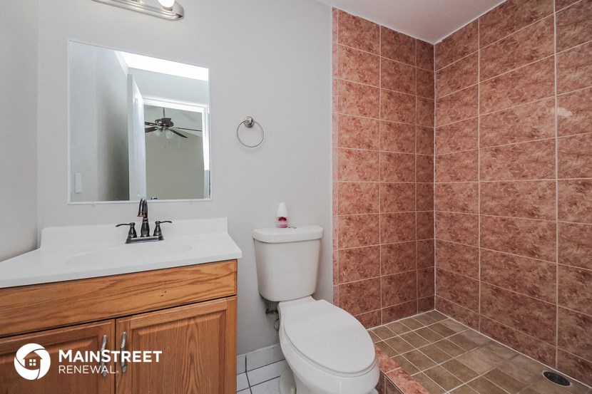 a bathroom with a toilet and a sink and a mirror
