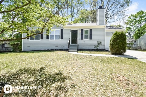 a white house with a lawn in front of it