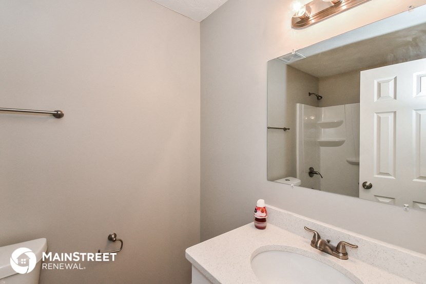a bathroom with a sink and a mirror and a shower
