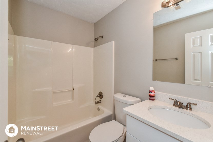 a bathroom with a sink toilet and a bath tub