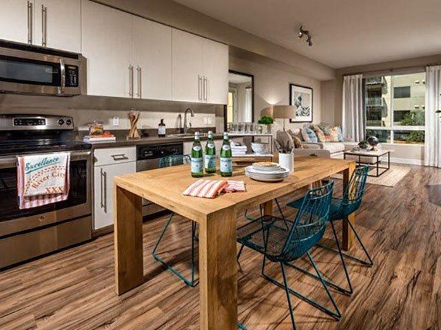 a kitchen and dining room with a wooden table