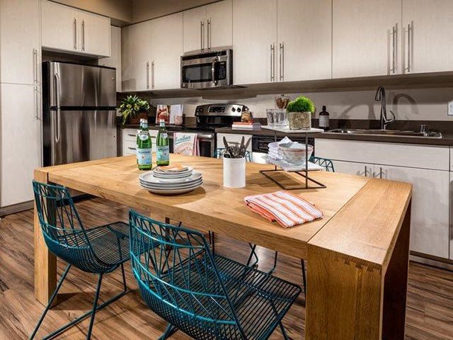 a kitchen with a wooden table and chairs