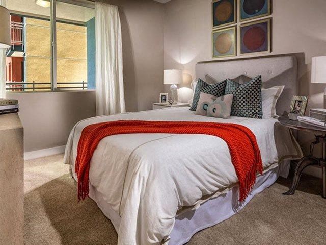 a bedroom with a bed and some pillows