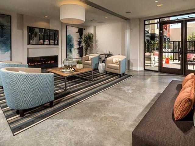 a living room with couches and chairs and a fireplace