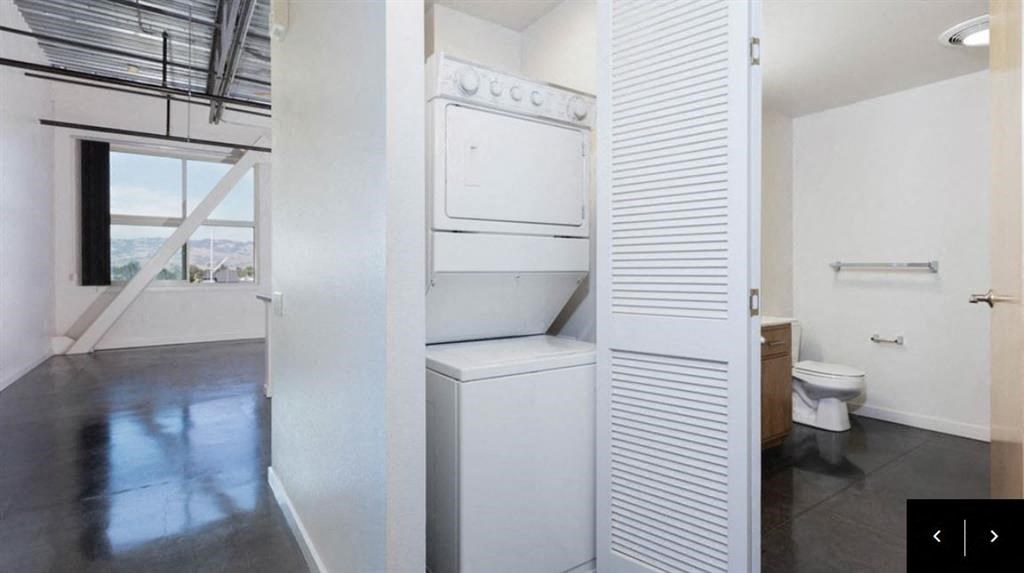 an empty bathroom with a toilet and a white closet