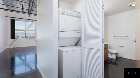 an empty bathroom with a toilet and a white closet