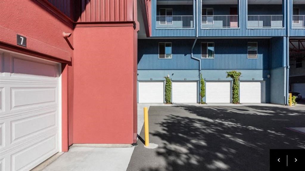 a red and blue building with white garage doors