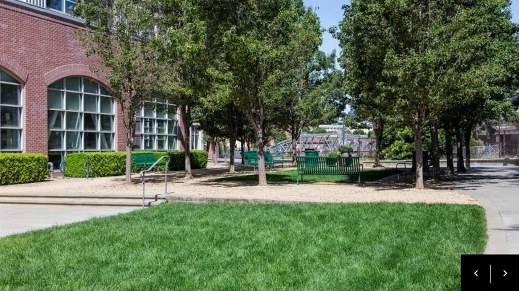 a park with benches in front of a building