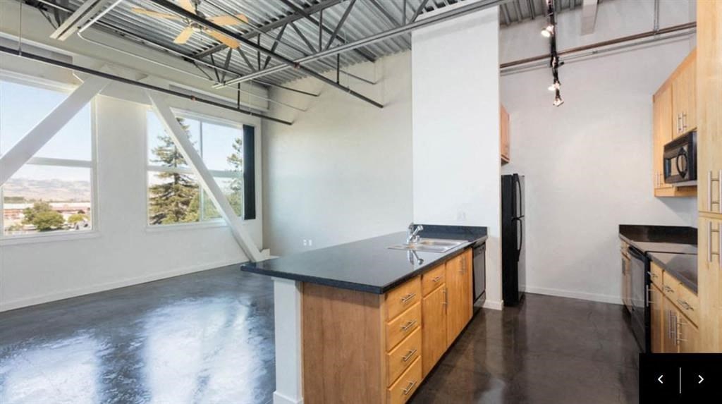 a kitchen with a counter top and a large window