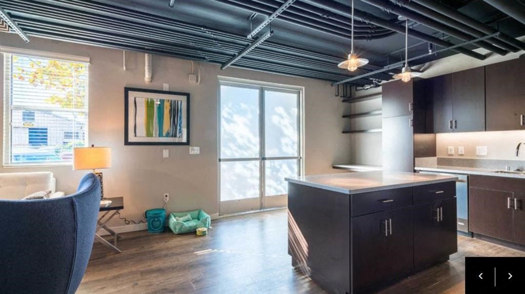 a kitchen and living room with a large window