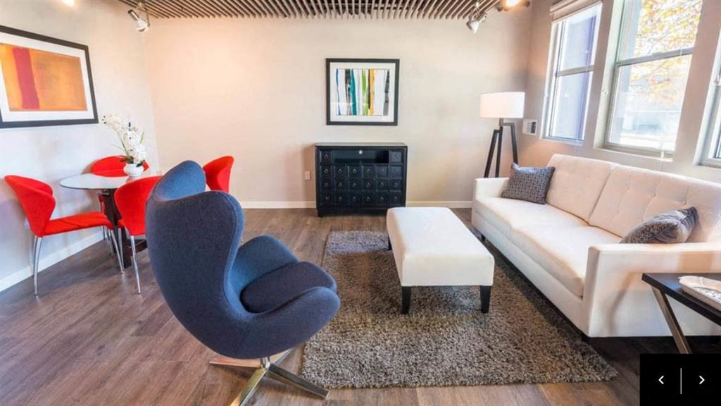 a living room with a couch and chairs and a table