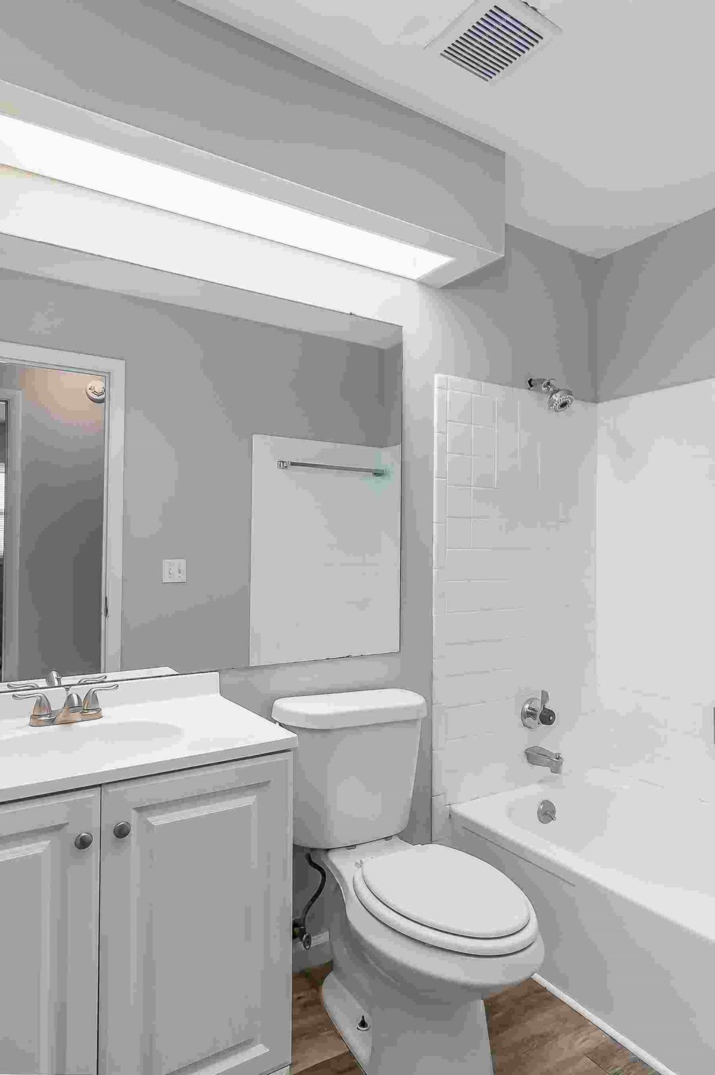 A white toilet sits next to a sink in a bathroom.