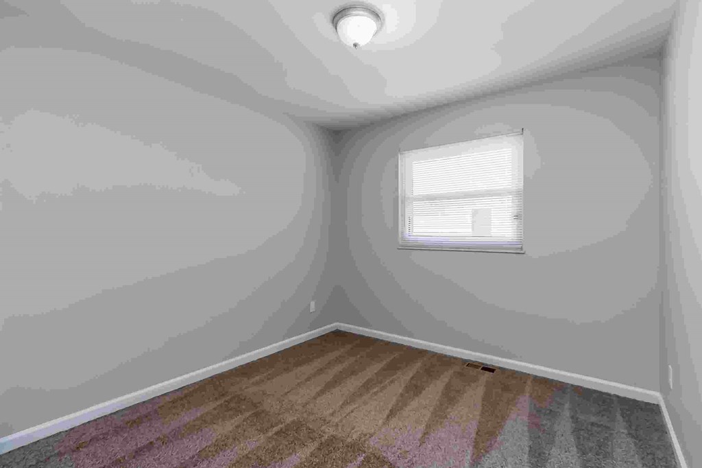 A room with a window and a skylight.