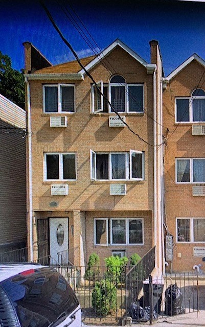 A brown building with a white door and windows.