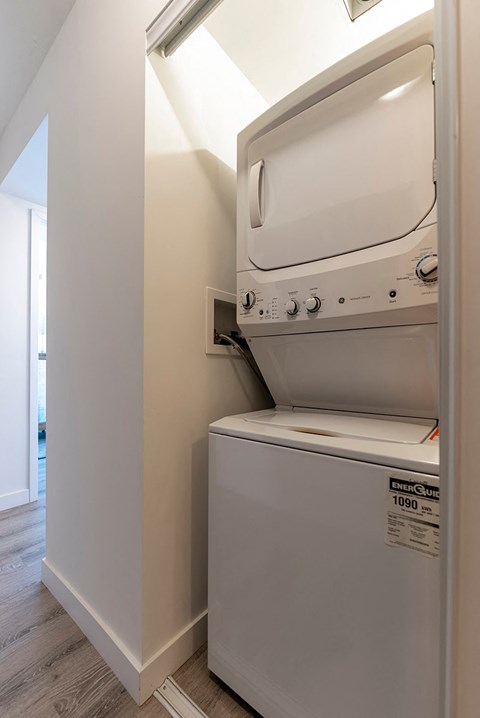 a white washer and dryer in a room with a washing machine