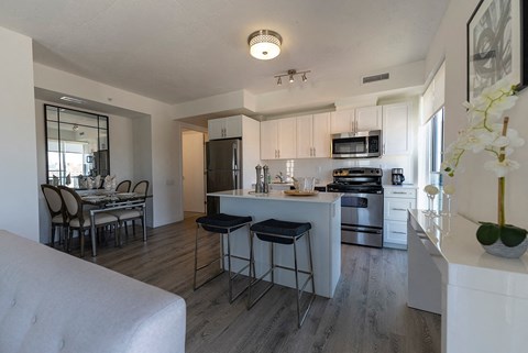 an open kitchen and dining area with a table and chairs