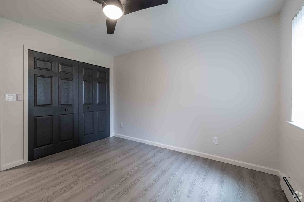 a empty room with white walls and a black door