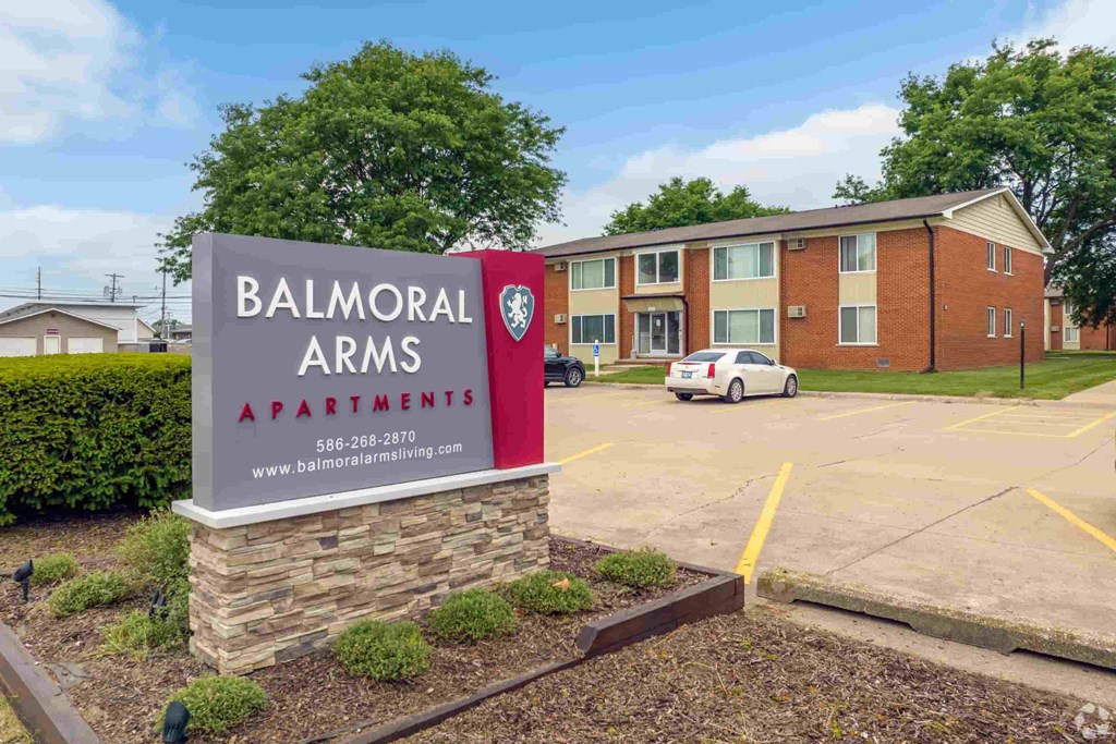 an apartment building with a sign