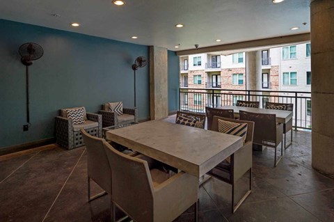 A dining room with a table and chairs.