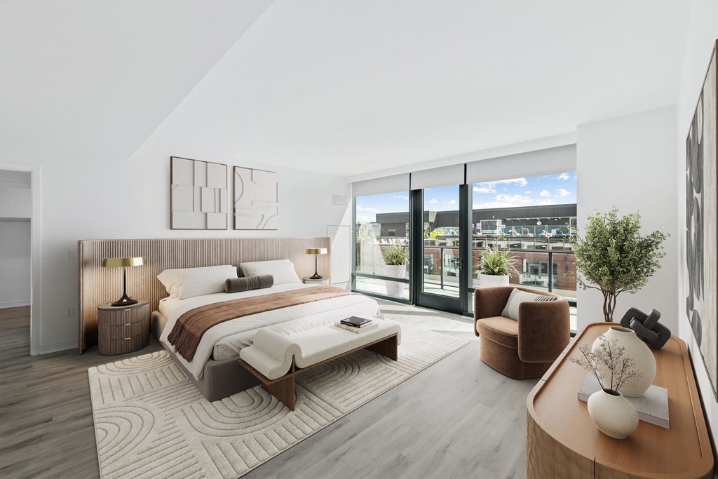 a bedroom with a bed and a couch and a balcony