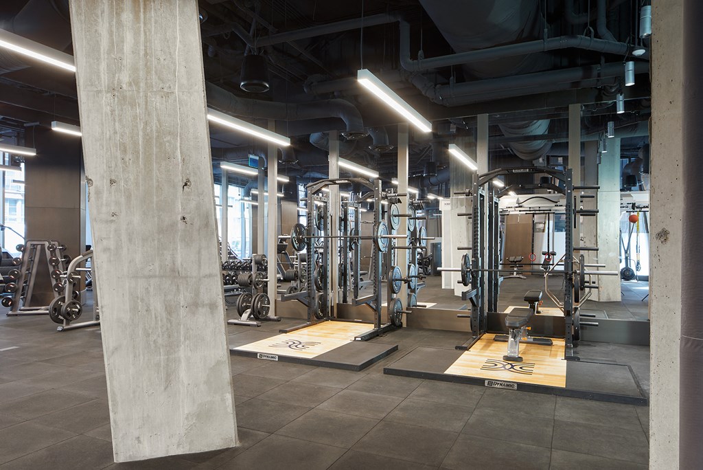 a gym with a lot of machines and wires in it