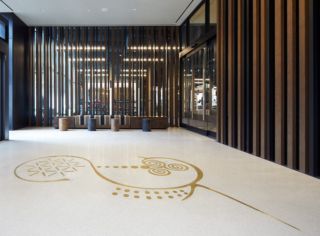 a large logo on the floor of a lobby of a building