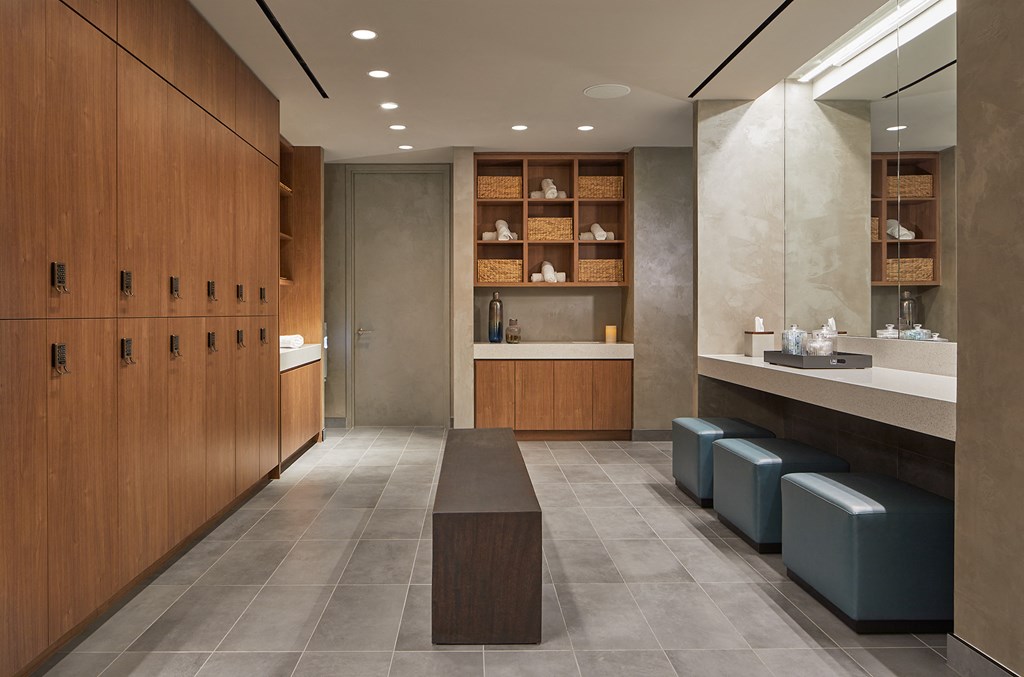 a locker room with a row of wooden cabinets and a bench