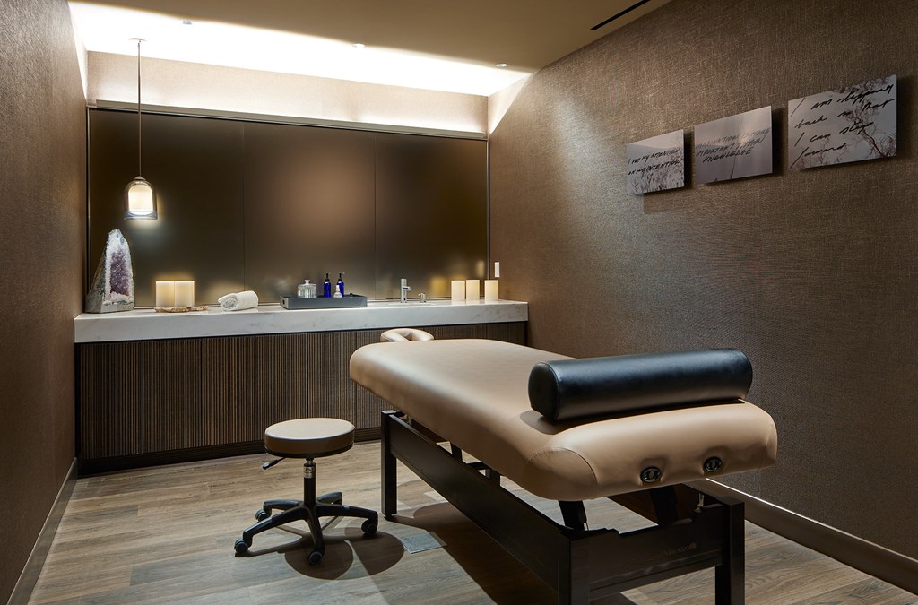 a hair salon with a brown chair and a counter