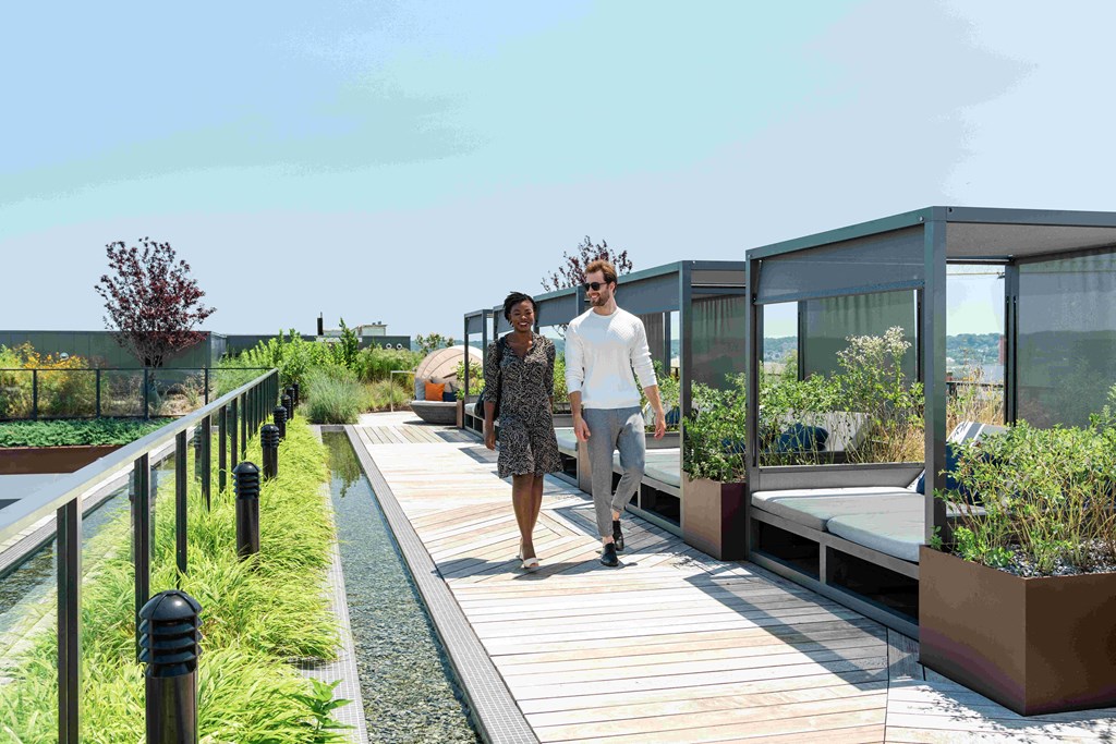 a man and a woman walking on a roof terrace