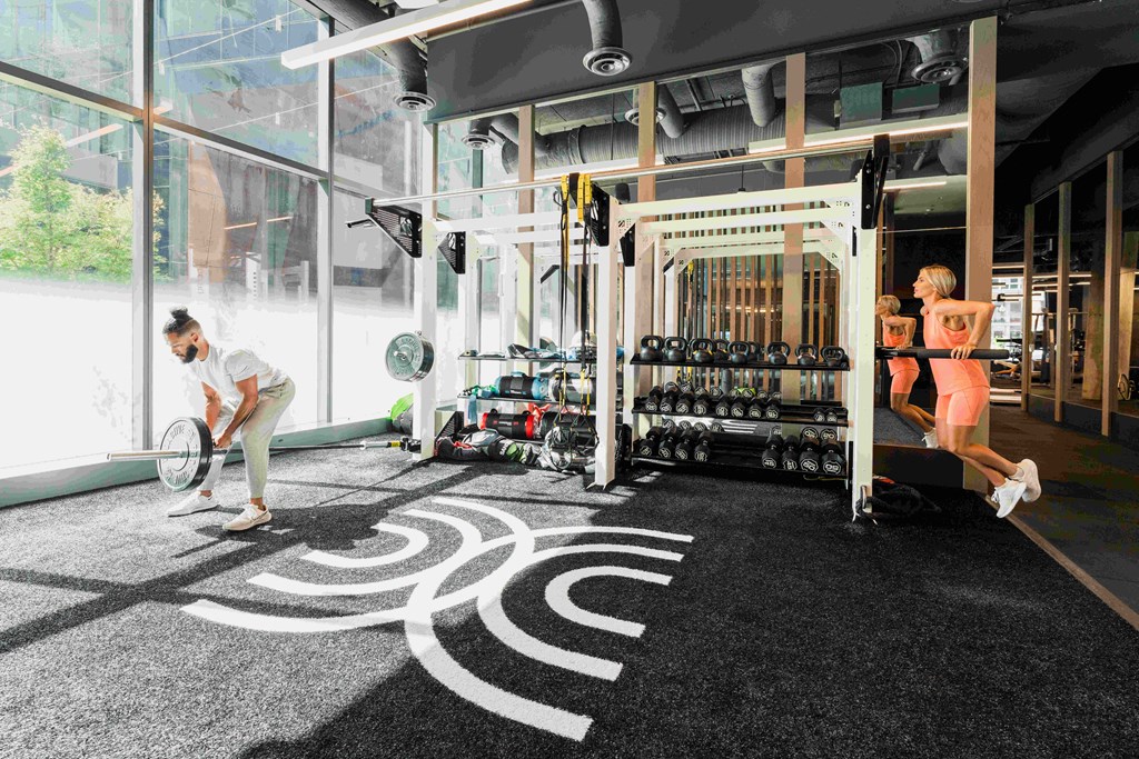 a woman working out in a gym with a swirl design on the floor