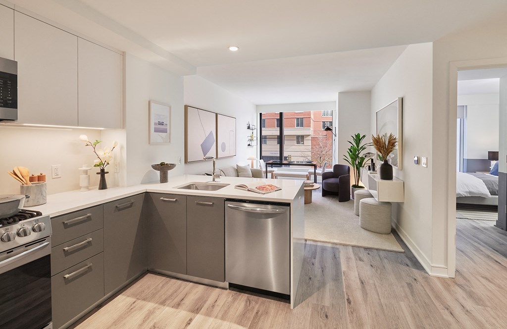 a kitchen with stainless steel appliances and a view of a living room