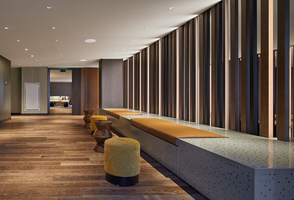 a row of benches in a hallway with wooden dividers