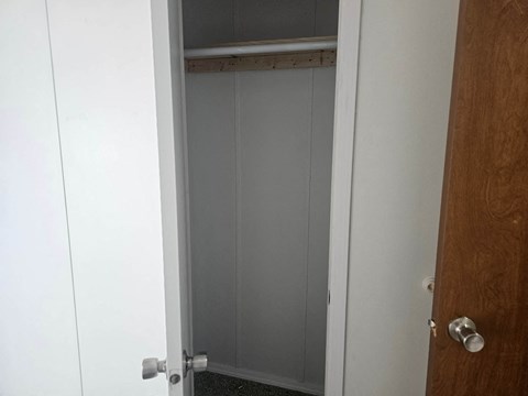 A white door with a silver handle is open.