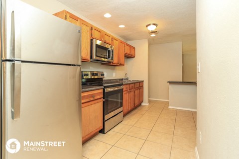 a kitchen with stainless steel appliances and wooden cabinets