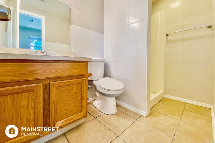 a bathroom with a toilet and a sink and a shower