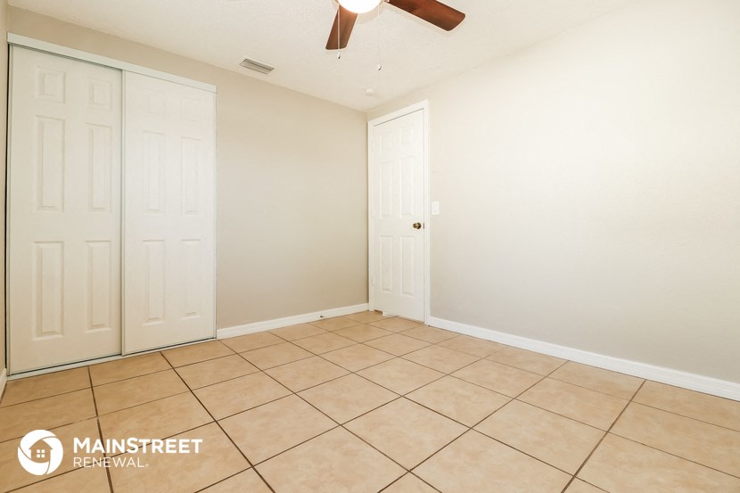 a empty room with two closets and a tiled floor