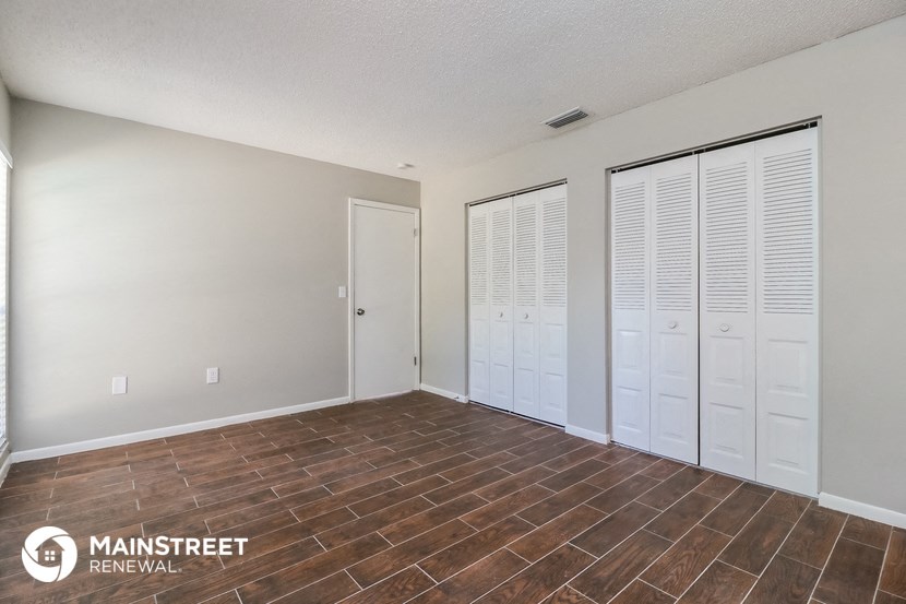 the living room and closet of an apartment at the flats at obsidian