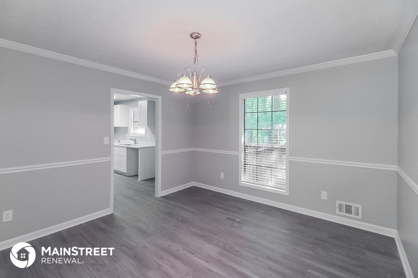 the living room of a renovated house and white walls